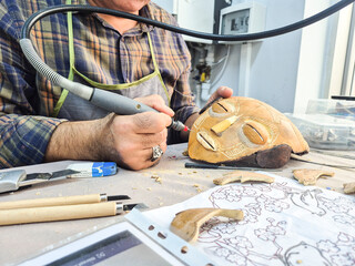 Artist makes mask with water gourd