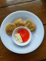 Crispy Fried Bites Served with Sauces on a Plate