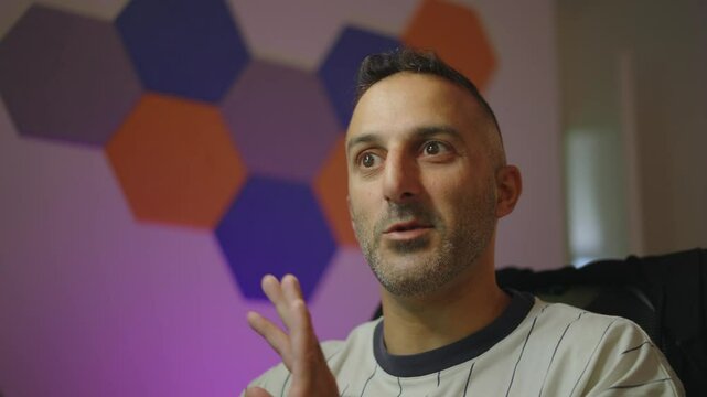 Fast-paced footage of a Network influencer blo energetically explaining modern interior design, with vibrant geometric wall patterns and dynamic lighting creating a bold and stylish atmosphere