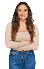 Fototapeta premium Young hispanic girl wearing casual clothes happy face smiling with crossed arms looking at the camera. positive person.