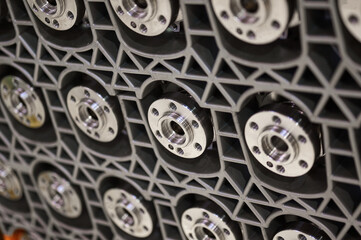 Lots of crankshafts for car engines. The shafts are installed in special boxes, only the connecting flanges are visible