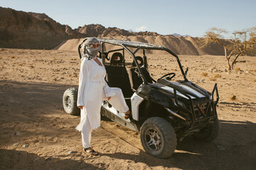 Woman tourist on quad bike ATV safari with desert background of Sharm El Sheikh Egypt