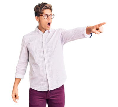Young handsome man wearing business clothes and glasses pointing with finger surprised ahead, open mouth amazed expression, something on the front - Powered by Adobe