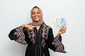 excited and happy african muslim lady holding some money