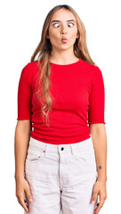 Fototapeta premium Young beautiful blonde woman wearing casual clothes making fish face with lips, crazy and comical gesture. funny expression.