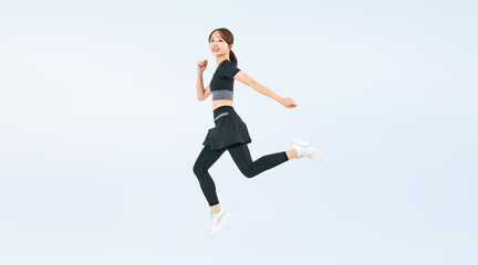 Obraz premium スポーツウェアを着てジャンプする女性の全身写真