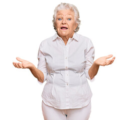 Senior grey-haired woman wearing casual clothes clueless and confused expression with arms and...