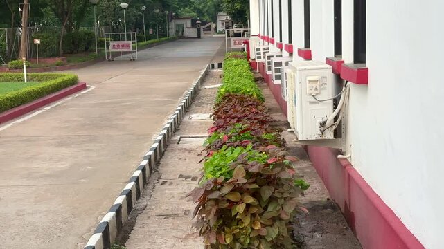 A line of windows and split air conditioning unit installed at the building