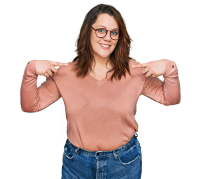 Young plus size woman wearing casual clothes and glasses looking confident with smile on face, pointing oneself with fingers proud and happy.