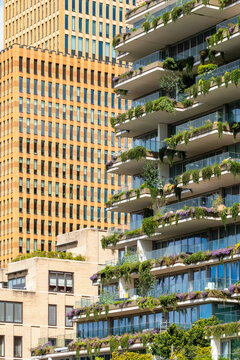 Stunning architecture featuring balconies adorned with greenery contrasting against a bright urban backdrop, embodying modern urban living through innovative design in Amsterdam
