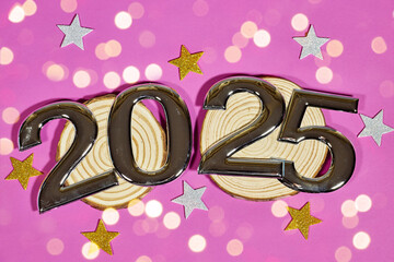 golden numbers 2025 two thousand twenty five new year with colorful stars confetti on wooden trunk, bokeh light