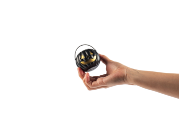 Halloween pumpkin-shaped plastic cup in hand, transparent background