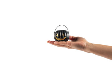 Halloween pumpkin-shaped plastic cup in hand, transparent background