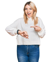 Young caucasian woman wearing casual winter sweater in hurry pointing to watch time, impatience,...
