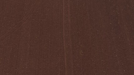 Top down aerial ploughed field track follow