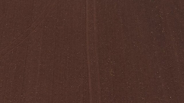 Top down aerial ploughed field track follow