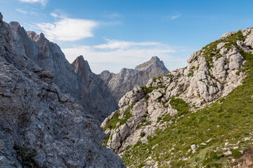 Hiking trail with scenic view of rugged mountain peak Razor in Julian Alps seen from Triglav...