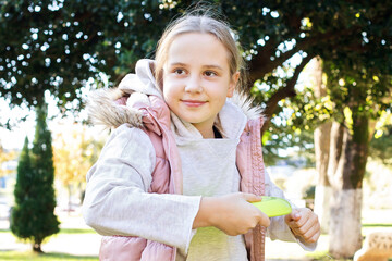 Child with flying disc in park outdoors portrait