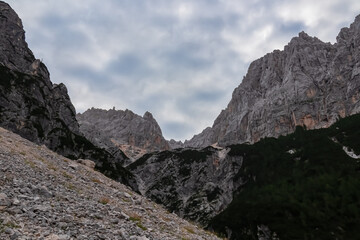 Hiking trail with scenic view of rugged majestic mountain peaks of Julian Alps seen from Krnica...