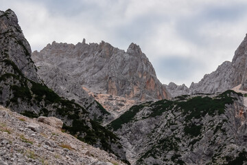 Hiking trail with scenic view of rugged majestic mountain peaks of Julian Alps seen from Krnica...