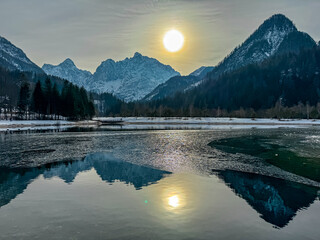 Scenic view of frozen lake Jezero Jasna in Kranjska Gora along road to Vrsic Pass in winter....