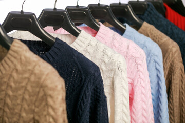 Obraz premium Warm and comfortable sweaters in neutral and bright hues on display