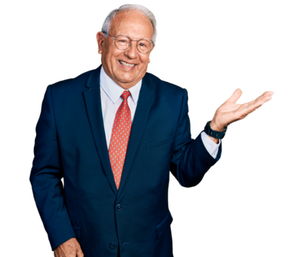 Senior man with grey hair wearing business suit and glasses smiling cheerful presenting and pointing with palm of hand looking at the camera.