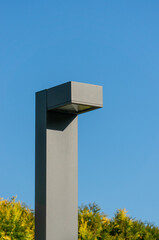 Modern lamppost with lighting lantern at top against blue autumn sky. Krasnodar City Park or...