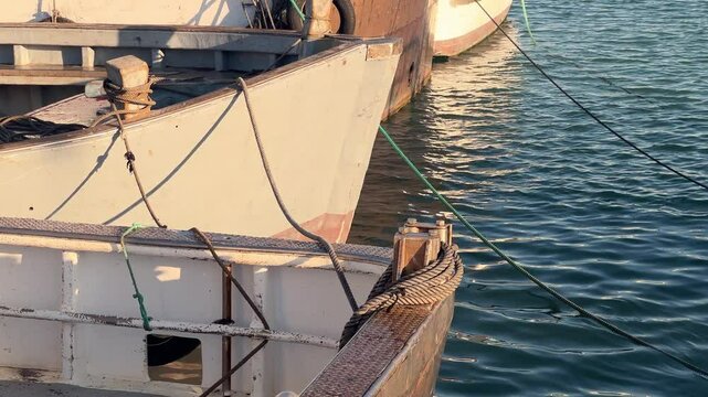 Close-up of the prows of a moored boats. Daylight