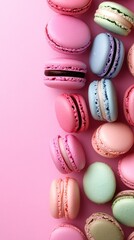 Fototapeta premium A colorful arrangement of macarons on a pink background, showcasing their delicate textures.