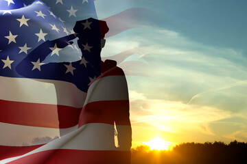 Silhouette of a police officer against the sunset. American flag against the sunset. National Law...