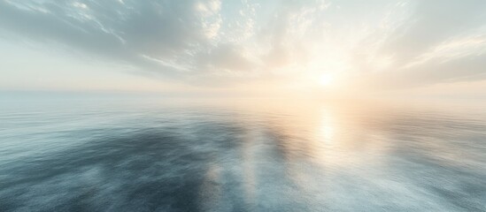 Obraz premium Calm ocean reflecting a hazy sunset.