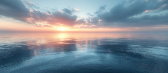 Obraz premium Serene sunset reflecting on calm ocean water.