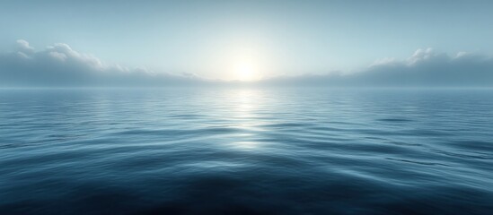 Obraz premium Serene ocean sunrise with misty horizon.
