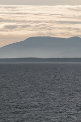 Vancouver island coastline during sunset, view from a ferry on the water