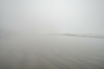 Chesterman beach all foggy on a moody, cloudy day. Near Tofino, Vancouver Island, British Columbia,...