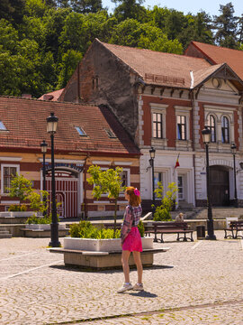 Woman walking on the central street of the historic town of Rasnov. The Rasnov Fortress was built on a hill between 1211 and 1225, during the reign of the Teutonic Knights of Burzenland.