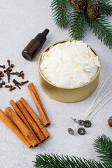 Soy vox in bulk, in a metal container, wicks, aroma oil, cinnamon, spices, Christmas tree on a...
