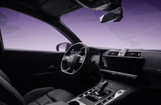 Interior of DS7 Crossback. Wide angle view from rear passenger seat: center console, dashboard and steering wheel of french suv crossover in front of purple background. Kyiv, Ukraine - June 14 2020.