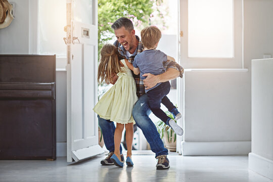 Excited, father and children with hug by door for welcome, greeting and happy to return home. Reunion, man and kids by doorway with embrace, connection and arrival from business trip with affection