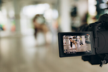Young female blogger recording sports video at home