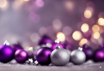 On a blurred festive bokeh background Christmas tree branches with purple and silver balls	