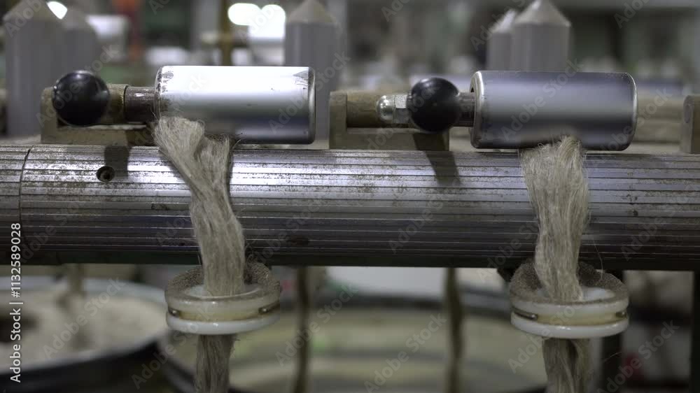Poster focused shot of flax fibers neatly aligned on industrial machinery, showcasing precision in the text