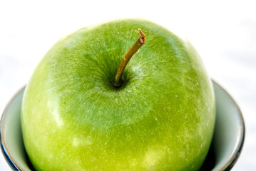 Close up of green apple and stalk