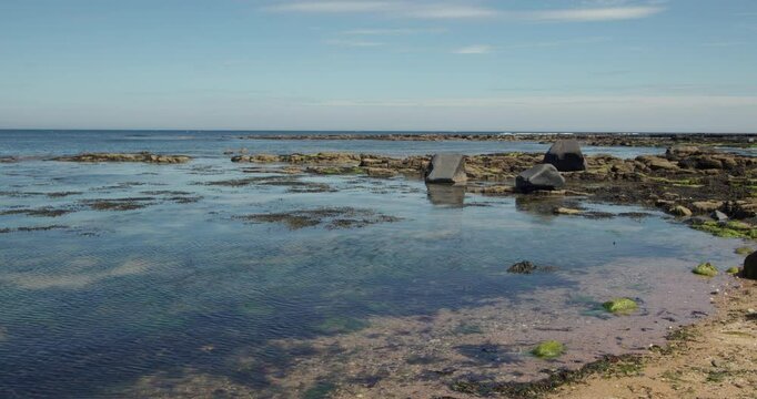 wide shot of exposed rocks at low tide at Longhoughton beach of the howdiemony sands. Alnwick.