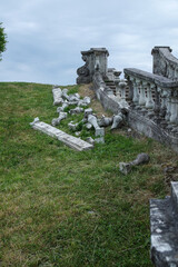 view of an old destroyed stone staircase against the backdrop of a green lawn