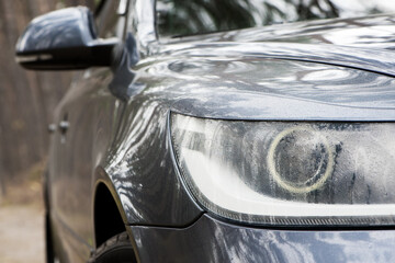 headlight of modern prestigious car. beautiful headlights of a car. dark gray color. part of the front, the car is unrecognizable. glowing headlight, illuminates on a sports car. auto close-up
