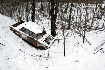 Accident on a winter snowy track. car skidding and falling into a ditch due to ice. Safety and poor...