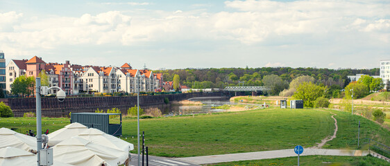 The waterfront of the Warta River in Poznań, with a promenade along the riverbank