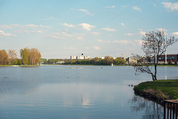 Scenic view of Lake Malta in Poznań, Poland, surrounded by lush greenery and recreational areas © Yunona